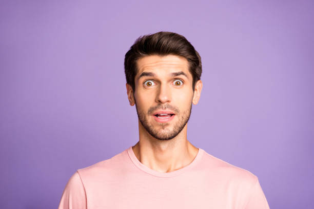 Man in pink shirt with a surprised expression to get the success at Mental Health Institute